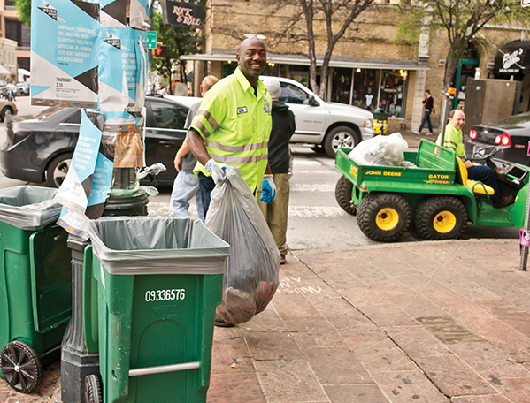 ARR employees in front of trash carts