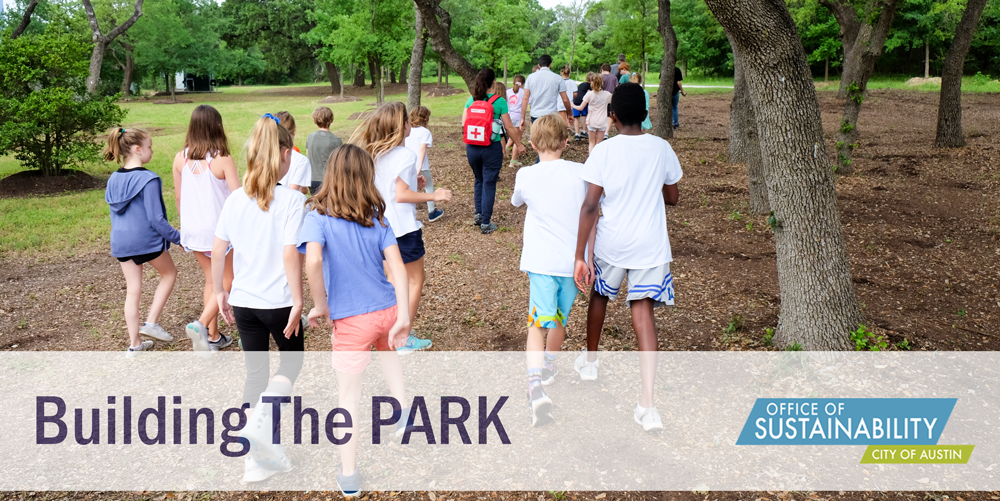 Photo of lots of school-age kids walking on a trail. Photo is shot from behind. The text overlay reads "Building The PARK". There is an Office of Sustainability logo in the lower right hand corner.