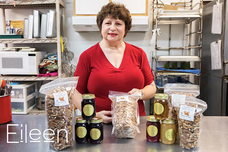 Eileen in her commercial kitchen with bagged pecans in the foreground.