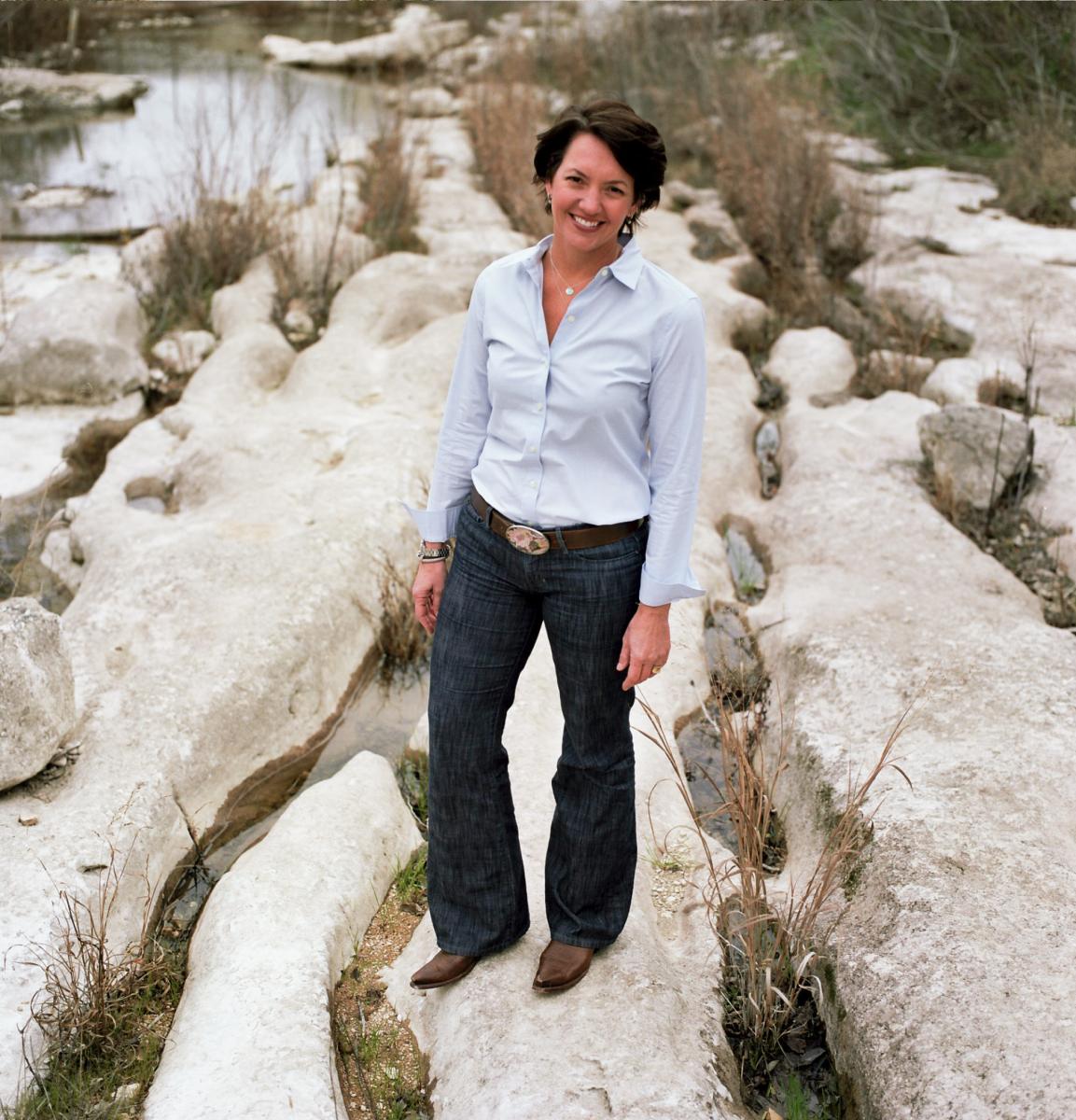 Laura Huffman standing in a creek bed.