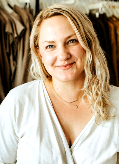 Headshot of Miranda Bennett. She has blonde hair and is wearing a white top.